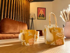 two coffee cups sitting on a table in a living room at Pełnia Mazur in Pasym +22 photos
