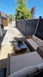 a patio with a couch and a table at Gemütliches Apartment in Kehl am Rhein