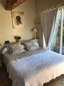a bedroom with a white bed with a window at Le Clôs Ste Anne in Eu