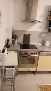 a kitchen with a stove and a sink in it at Apartment SAYA in Banja Luka +26 photos