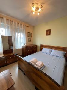 a bedroom with a bed with two towels on it at Lake View Apartment in Pogradec