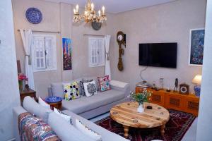 a living room with a couch and a table at Dar Halima in Rabat