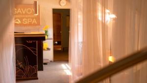 a hallway of a hotel with a sign on the wall at Hotel Savoy Špindlerův Mlýn in Špindlerův Mlýn
