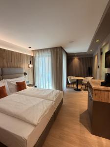 a hotel room with a large bed and a table at Alpen Relais in Fondo