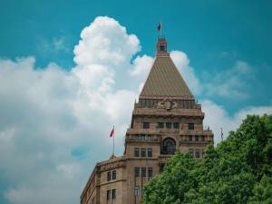 a building with a clock tower on top of it at Fairmont Peace Hotel on the Bund in Shanghai