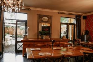 a dining room with tables and a mirror at Godiva Spa & Guesthouse in Groblersdal