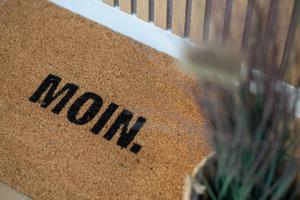 a sign with the word moroni on a wall at Mellenthin-Lodges "Seeigel" in Fehmarn