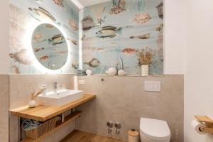 a bathroom with a sink and a toilet at Mellenthin-Lodges "Seeigel" in Fehmarn +9 photos