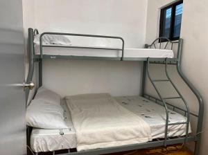 two bunk beds in a room with a window at Nomads Retreat House in Moalboal +2 photos