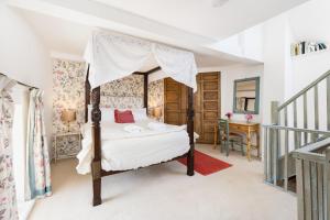 a bedroom with a four poster bed and a staircase at Upper Court in Kemerton +57 photos