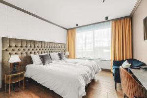 a bedroom with a large bed and a large window at Hotel Keflavik by Reykjavik Keflavik Airport in Keflavík +175 photos