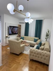 a living room with two couches and a tv at Stan na dan Alex in Bijeljina