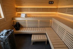 a sauna with two benches and towels in it at Chatička in Veľká Lomnica