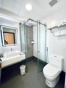 a bathroom with a shower and a toilet and a sink at The Track Homestay - Near Bai Dai Beach in Cam Lâm