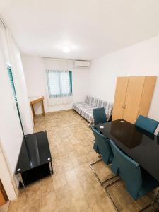a room with a table and chairs and a couch at Povlja Bungalows in Povlja +78 photos