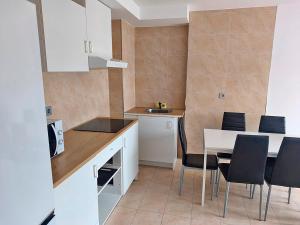 a kitchen with a table and chairs in a room at Apartamentos Illa de Arousa 3000 in Isla de Arosa +7 photos