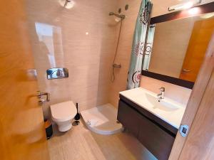 a small bathroom with a toilet and a sink at Apartamentos Illa de Arousa 3000 in Isla de Arosa