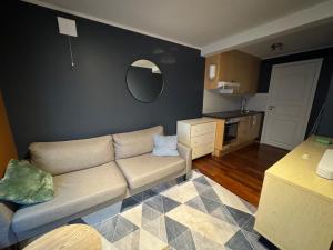 a living room with a couch and a kitchen at Leilighet i Vadsoe sentrum in Vadsø +1 photo