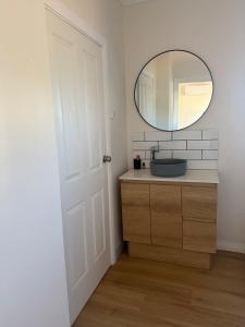 a bathroom with a sink and a mirror at Lamington Guesthouse in Kalgoorlie