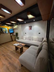 a living room with a couch and a table at Garden City Plaza Hotel in Cairo