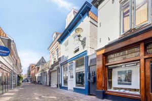 a row of buildings on a street at Boutique Hotel Alkmaar - City Rooms & Apartments in Alkmaar