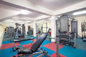 a gym with tread machines and a simulator at TSG Emerald View Hotel and SPA in Port Blair