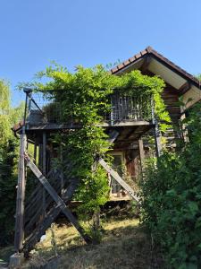 a tree house with a balcony on the side of it at Les Gites du Belvedere - Arbois in Arbois