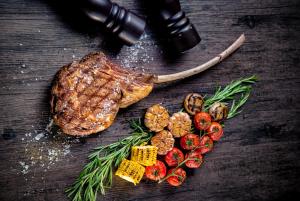 a piece of steak and vegetables on a table at InterContinental Beijing Sanlitun by IHG in Beijing