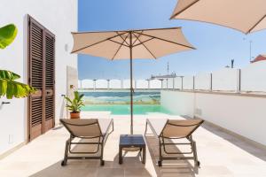 a patio with a table and chairs and a swimming pool at Palazzo De Castro in Squinzano