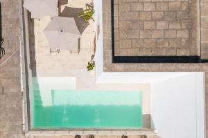 an overhead view of a pool and an umbrella at Palazzo De Castro in Squinzano