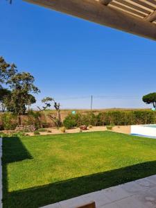 a view of a lawn with a swimming pool at Casa dos Foros in Odemira