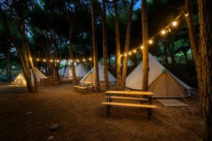 a group of tents and a picnic table with lights at Kampaoh Los Caños in Los Caños de Meca +49 photos