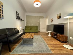 a living room with a couch and a tv at stadtRaum-berlin apartments in Berlin