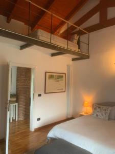 a bedroom with a bed and a loft at Camere con piscina Tenuta BRICCHETTO in Castagneto Po