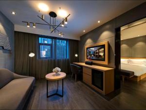 a hotel room with a bed and a table at Orange Hotel Beijing Shangdi Huandao in Beijing