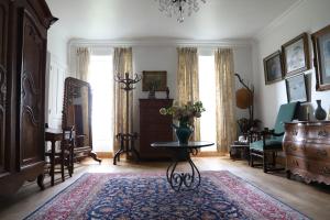 a living room with a table with a vase on it at Chambre d'hôtes chez Johannes et Adèle in Brive-la-Gaillarde