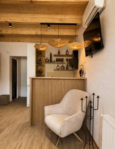 a living room with a chair and a bar at Mountain Shadow Racha in Ambrolauri