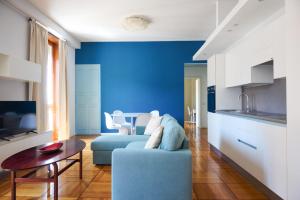 a blue living room with a couch and a table at Milan Retreats Duomo in Milan