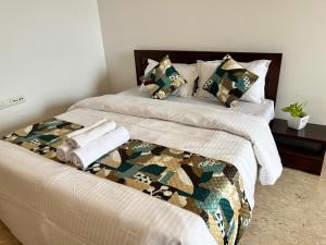 a bedroom with a bed with a camo bedspread at Luna Spaces-Riva Nr KIMS Hospital, Bayer House, TCS thane in Thane