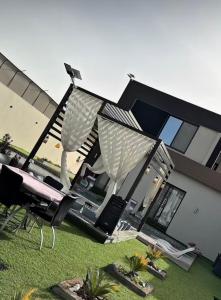 a house with a lawn with chairs and a staircase at THE VIEW chalet in Makhrabā