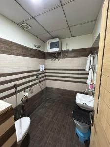 a bathroom with a toilet and a sink at Vida Hotel in Patiāla