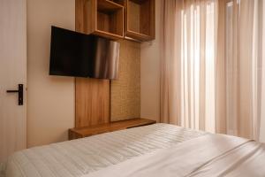 a bedroom with a bed and a flat screen tv at Seamar View Zante in Argassi