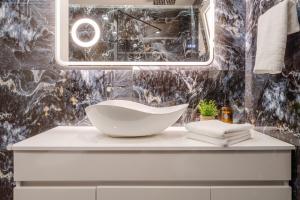 a bathroom with a bowl sink on a counter at Seamar View Zante in Argassi +47 photos