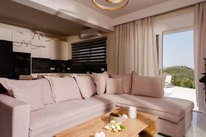 a living room with a couch and a table at Seamar View Zante in Argassi