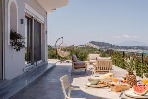 a patio with a table and chairs with a view at Seamar View Zante in Argassi
