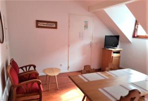 a living room with a table and a tv at Résidence Vignec Village by Actisource in Vignec +13 photos