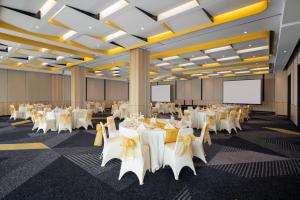 a conference room with white tables and chairs at Kampi Hotel Sunter in Jakarta +17 photos