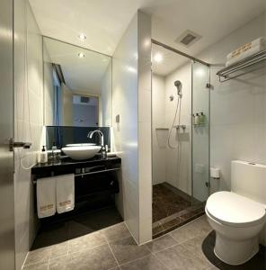 a bathroom with a toilet and a sink and a shower at Orange Hotel Beijing Shangdi Huandao in Beijing
