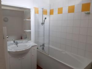 a white bathroom with a sink and a shower at Résidence Vignec Village by Actisource in Vignec