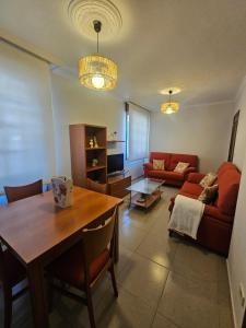 a living room with a table and a couch at Casa A devesa in Cangas de Morrazo